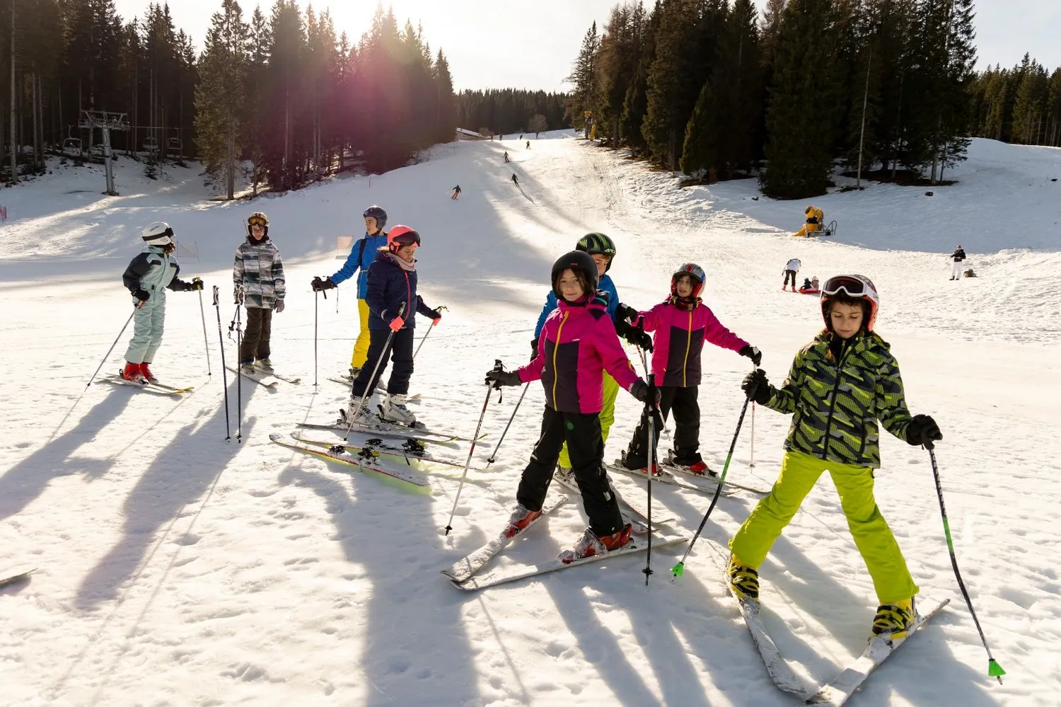 Bambini del Camp sugli sci sulla pista al sole
