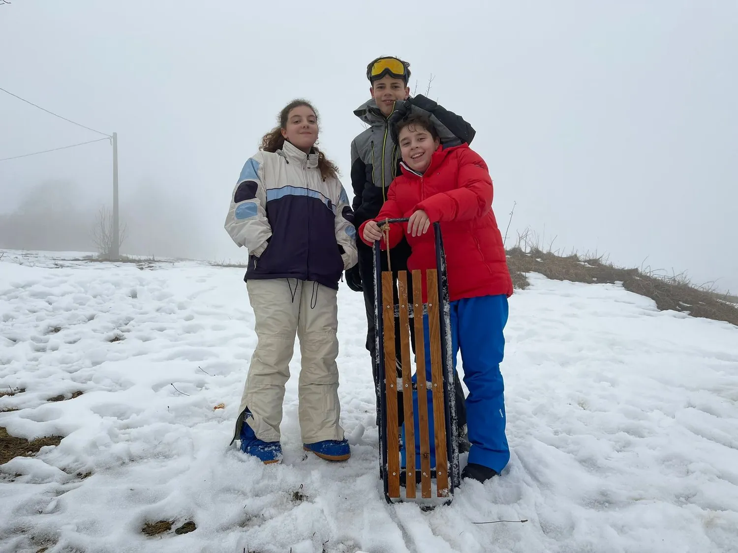 Ragazzi del Camp con la slitta di legno sulla neve